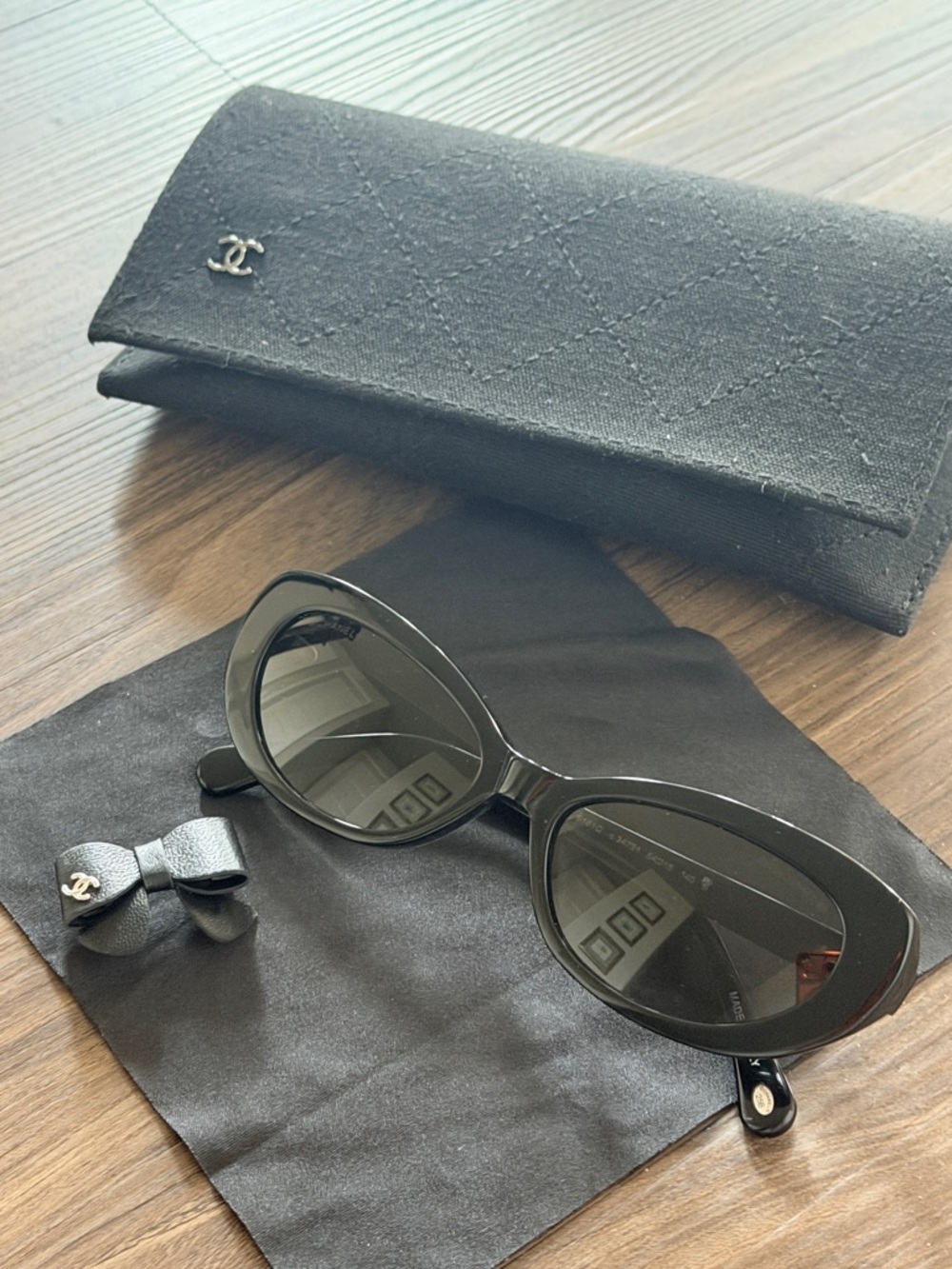 CHANEL Black Oval Sunglasses with Quilted Case and Bow Accent